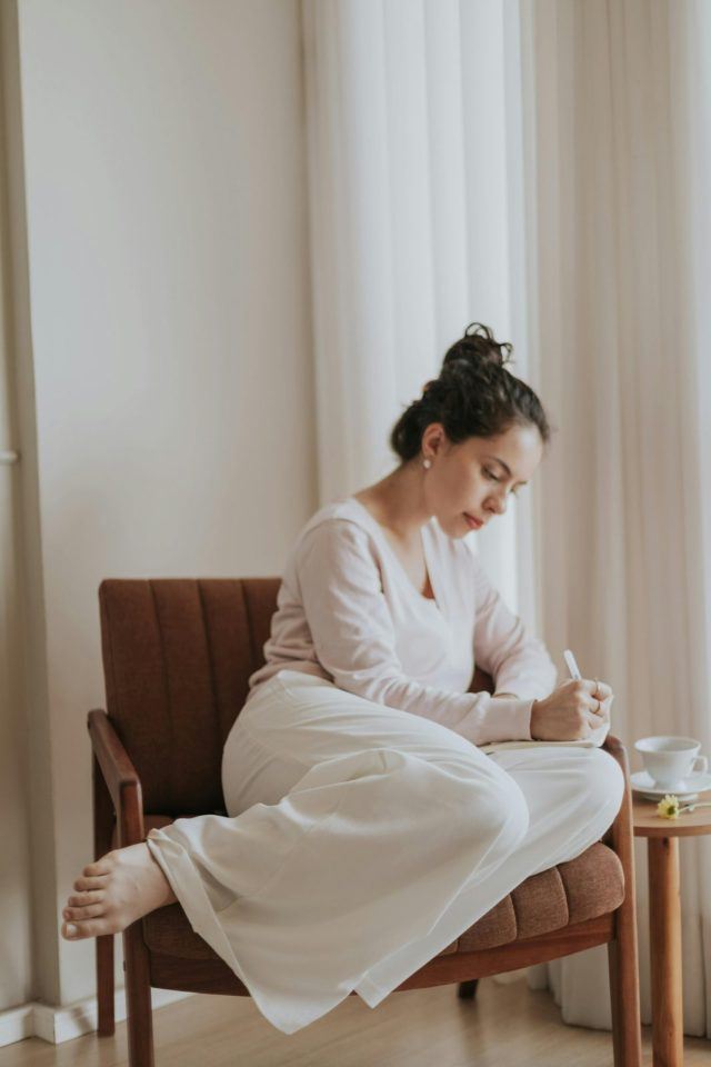 Person writing notes in a peaceful environment