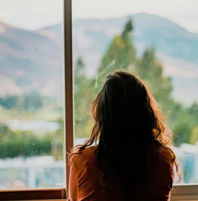 Person facing a scenic view representing self-reflection and growth